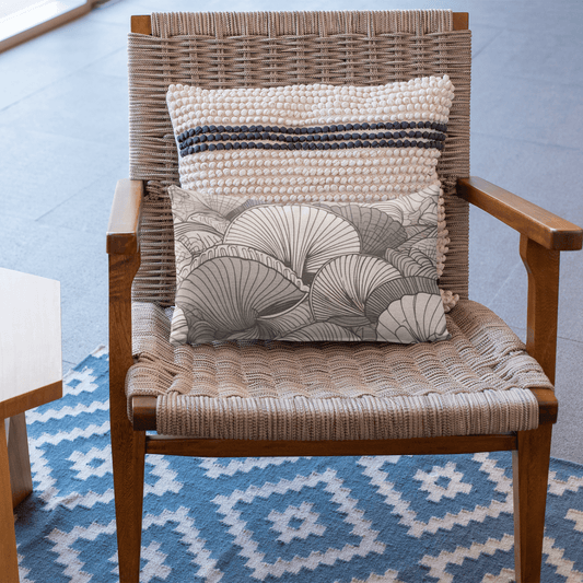 The Flynn modern nautical decorative lumbar pillow has a seashell motif in neutral colors. Cozy, cute, and charming, this pillow adds whimsy to any decor.