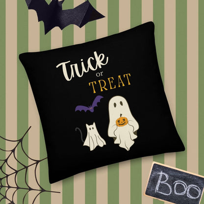 Halloween-themed pillow with ghost, cat, and 'Trick or Treat' text on a striped background.