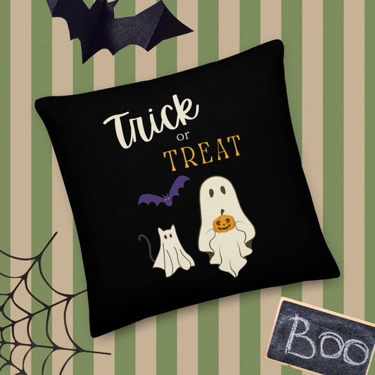 Halloween-themed pillow with ghost, cat, and 'Trick or Treat' text on a striped background.
