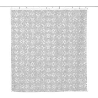 Shower curtain with geometric floral pattern on the front side and plain white on the reverse side.