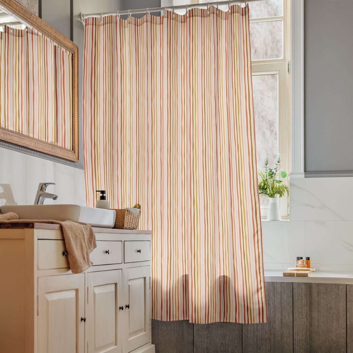 Bathroom with striped shower curtain, sink, and window.