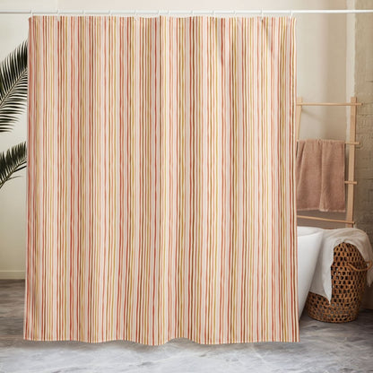 Striped shower curtain in a bathroom setting with a towel rack and basket.