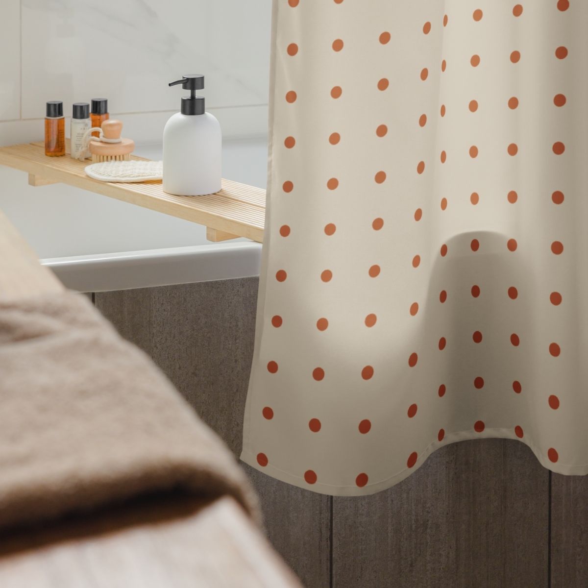 Bathroom with polka dot shower curtain, sink, and toiletries.