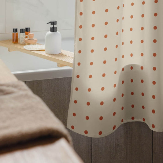 Bathroom with polka dot shower curtain, sink, and toiletries.