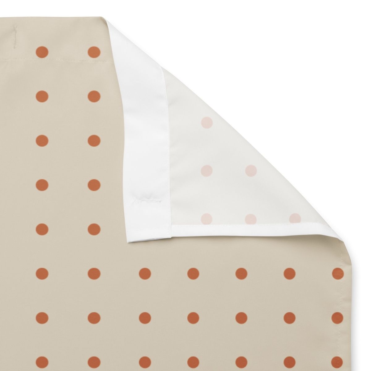 Fabric swatch with polka dot patterns on a beige background and white backside