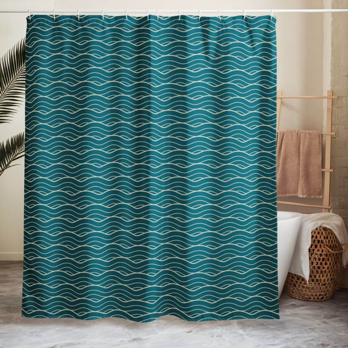 The Oliver shower curtain hangs in front of a tub with a wood wicker basket and wooden towel bar, doubling as a room divider.