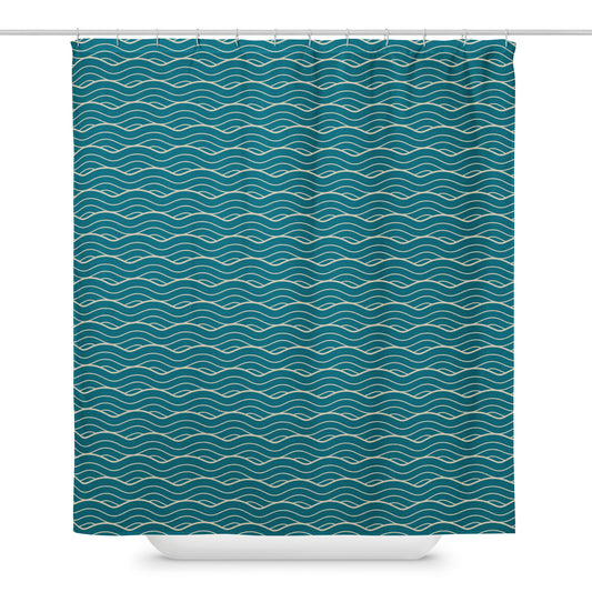The Oliver geometric ocean waves shower curtain hanging from a shower bar in front of a bathtub.