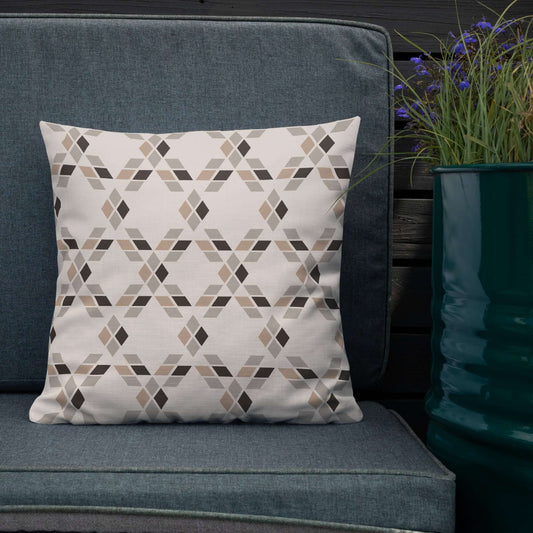The Saige decorative throw pillow on an outdoor patio couch surrounded by potted flowers