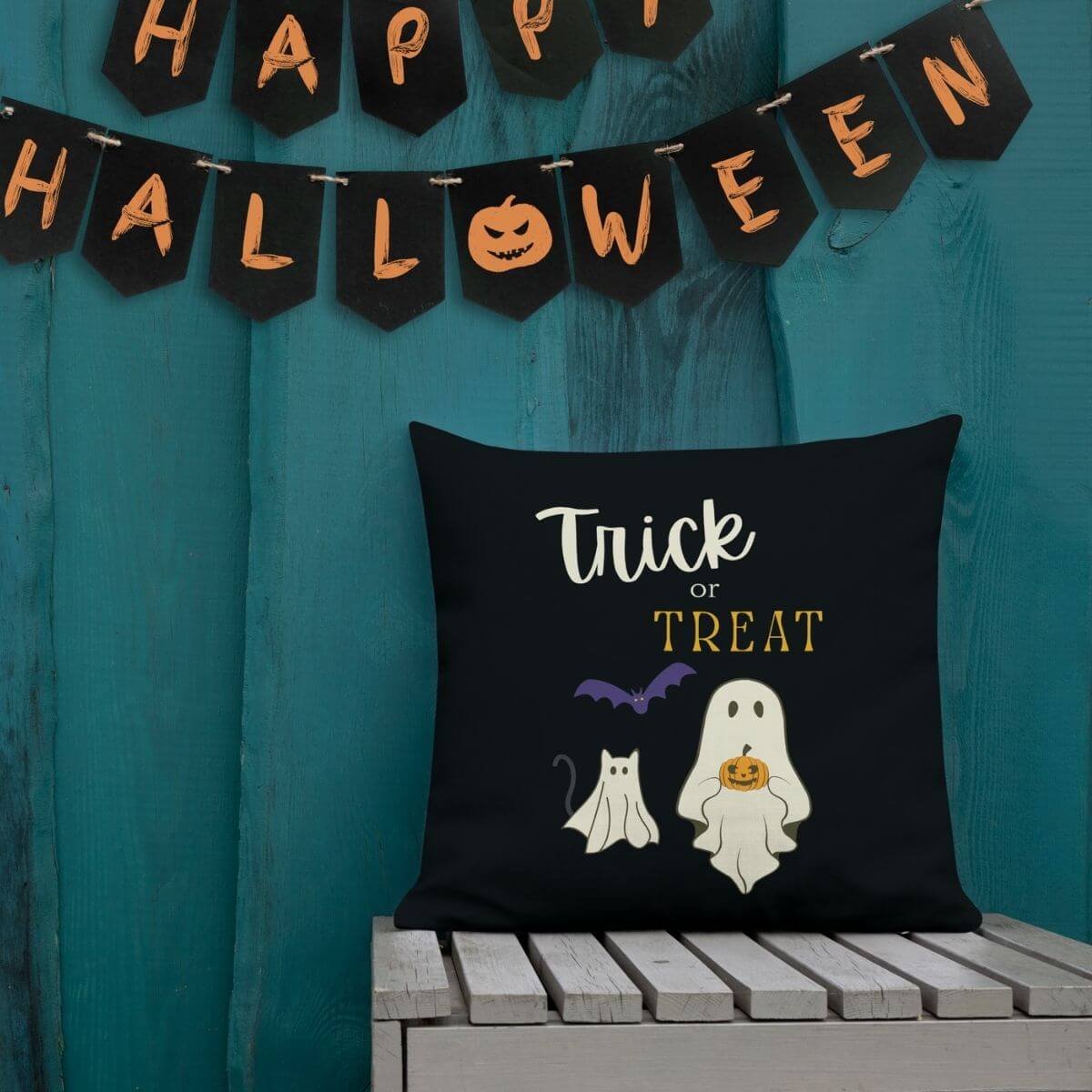 Halloween-themed pillow with 'Trick or Treat' text and graphics on a teal background with 'Happy Halloween' banner.