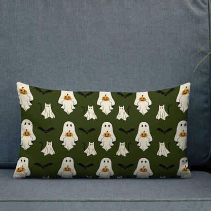 Decorative pillow with Halloween-themed pattern featuring ghosts, pumpkins, and bats on a green background.