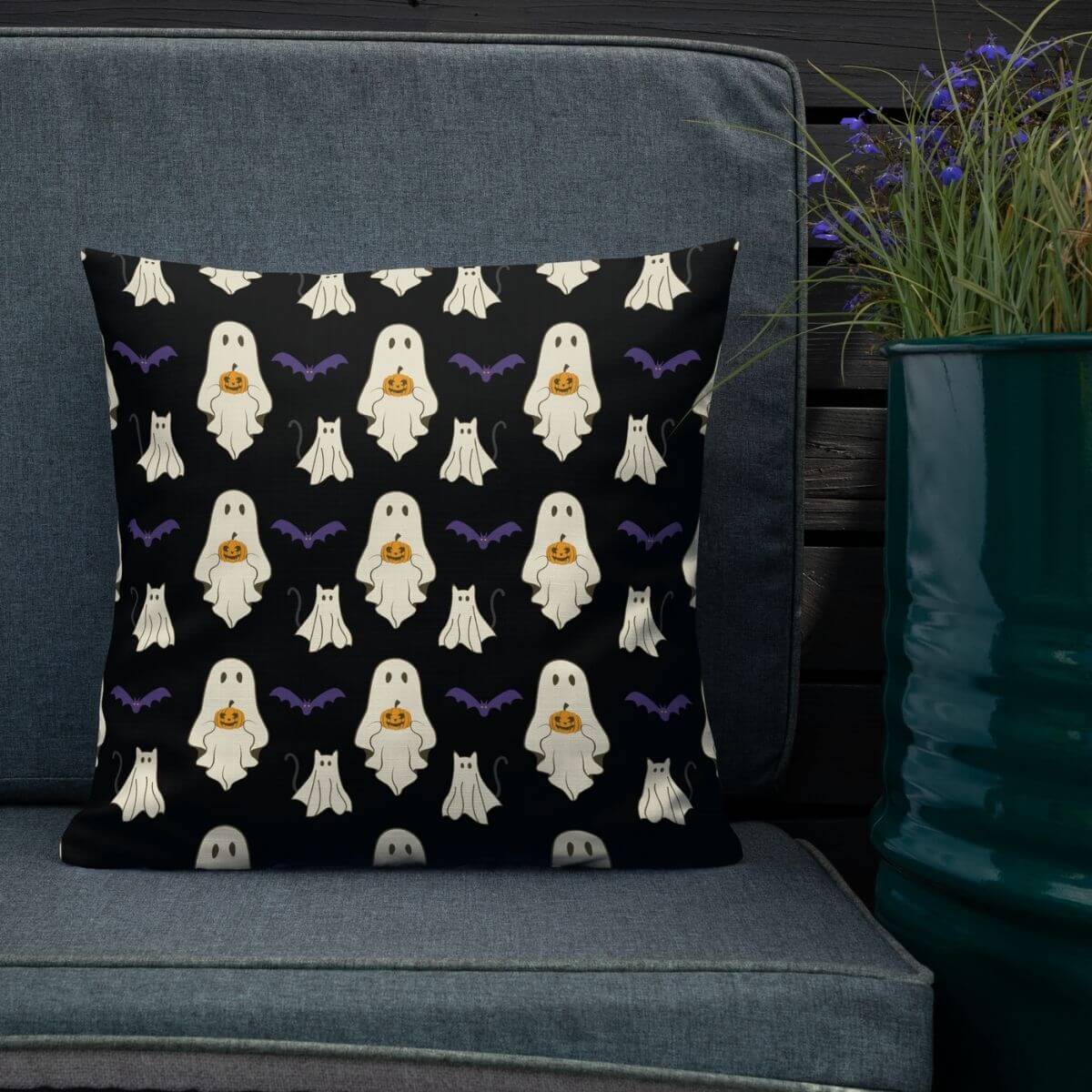 Halloween-themed pillow with ghost pattern on a gray couch