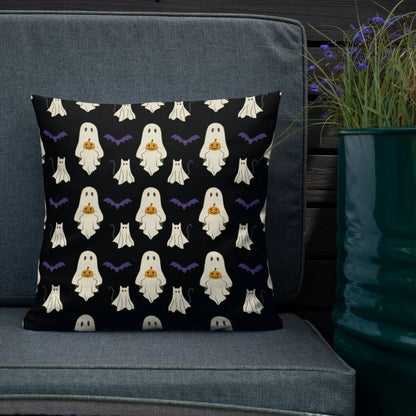 Halloween-themed pillow with ghost pattern on a gray couch