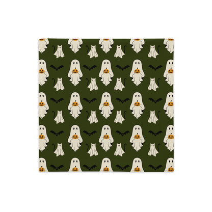 Halloween pillow cover with ghosts, cats, bats, and pumpkins against a green background.