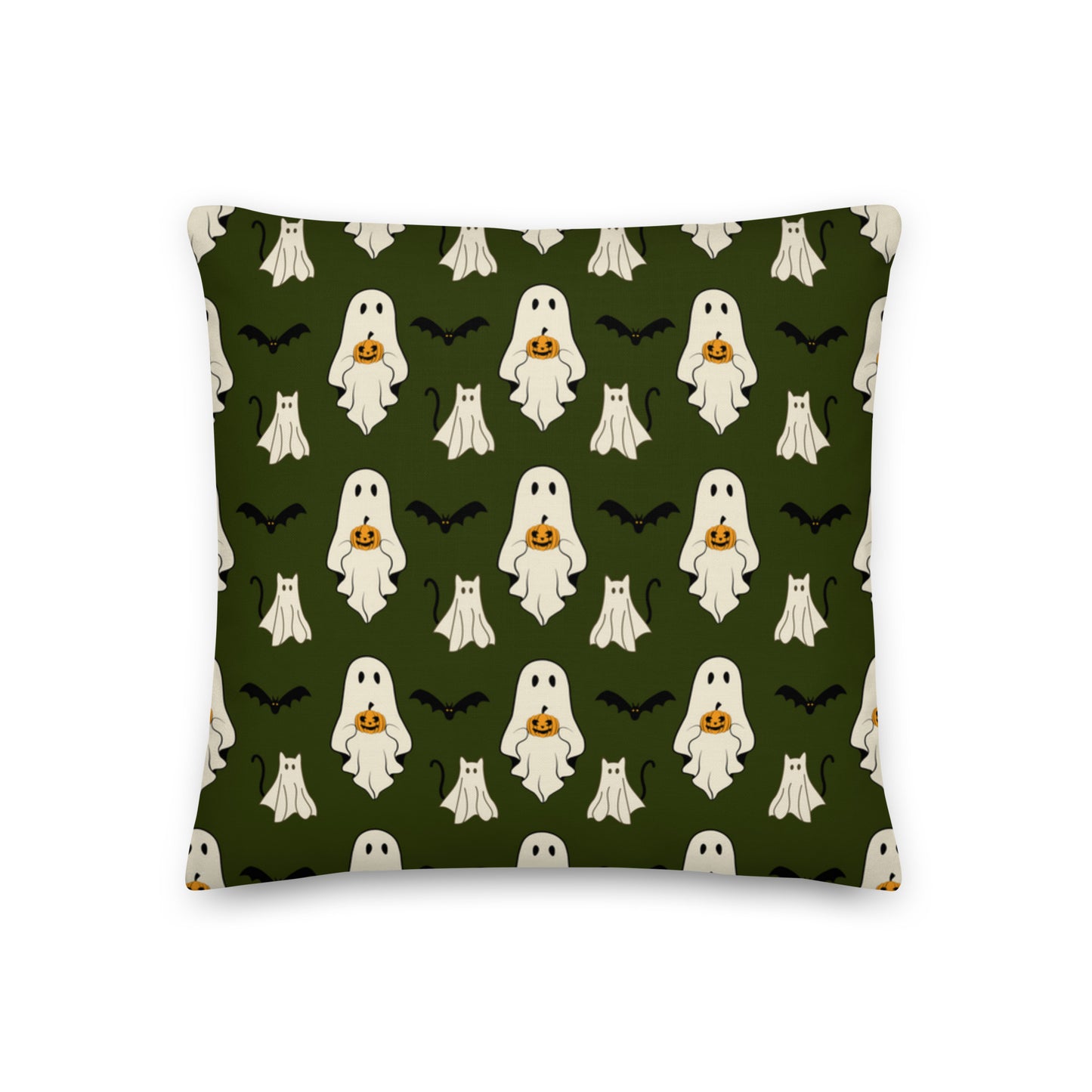 Halloween pillow with ghosts, cats, bats, and pumpkins against a green background.