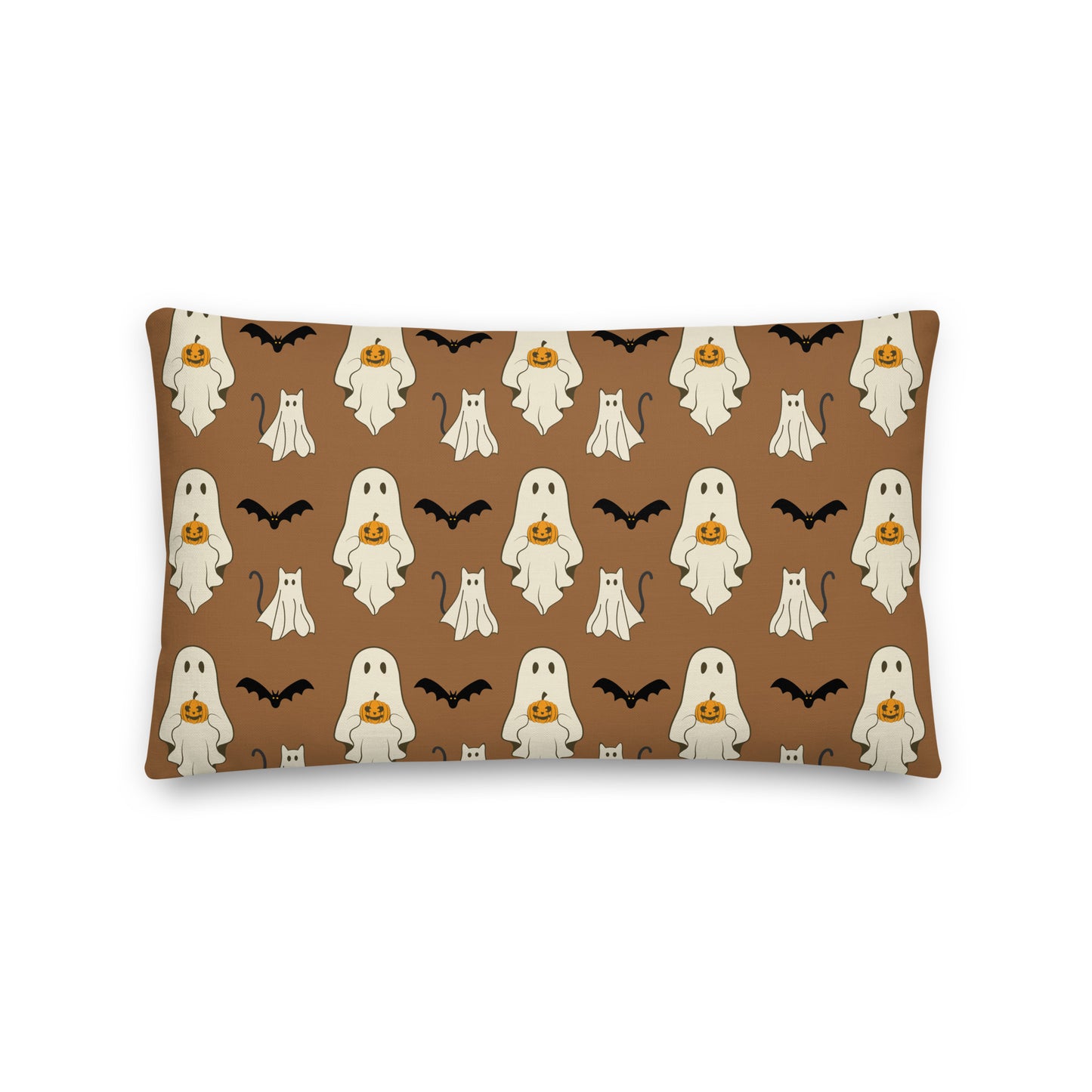 Halloween-themed pillow with ghosts, pumpkins, and bats on a brown background