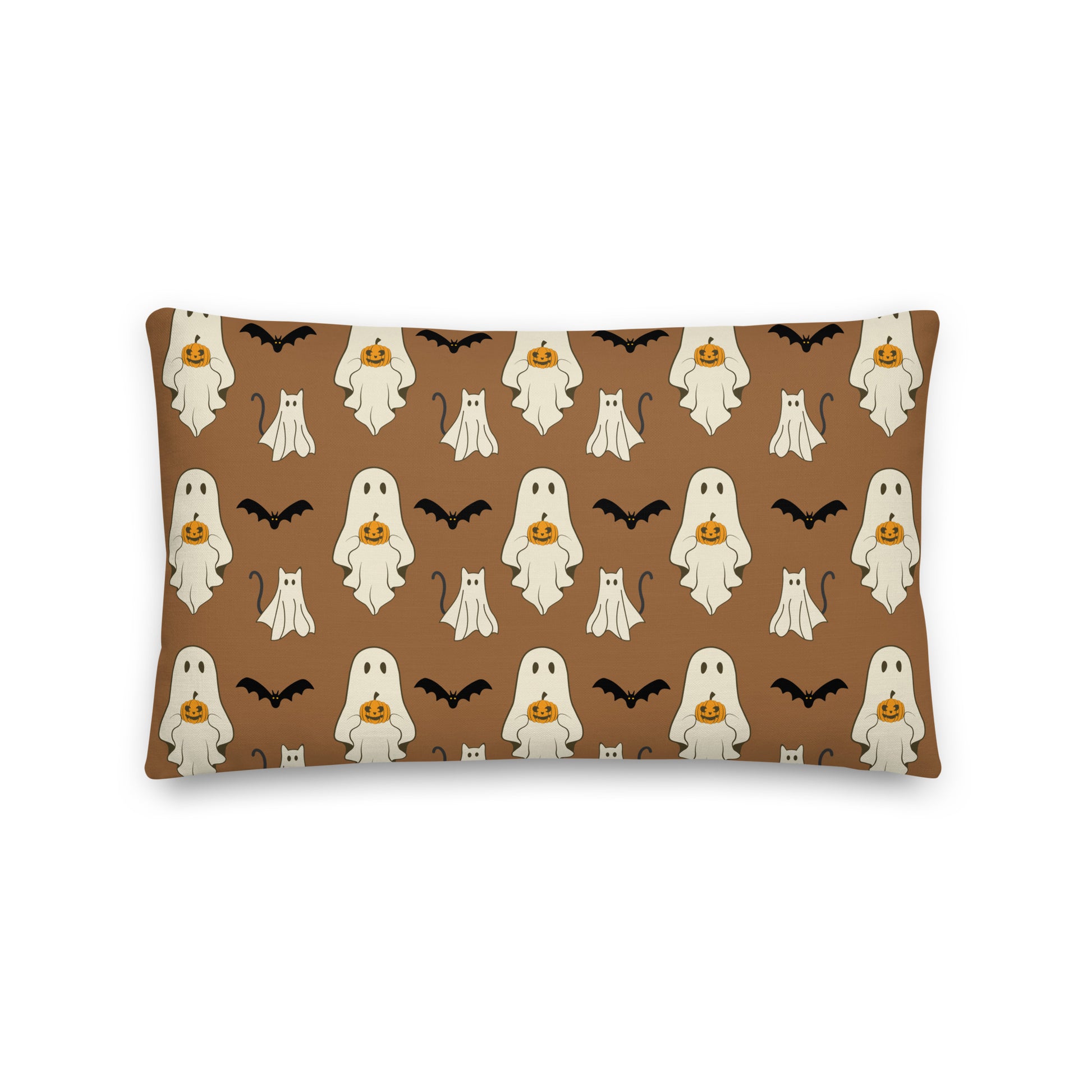 Halloween-themed pillow with ghosts, pumpkins, and bats on a brown background