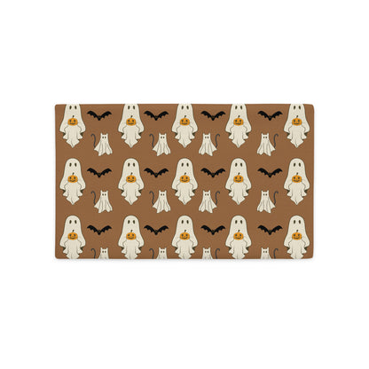 Halloween-themed lumbar pillow cover with ghosts, pumpkins, and bats on a brown background