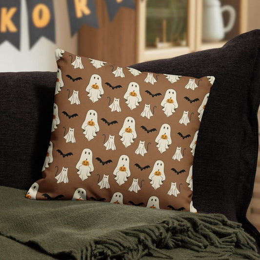 Halloween-themed decorative pillow with ghost pattern on a couch.