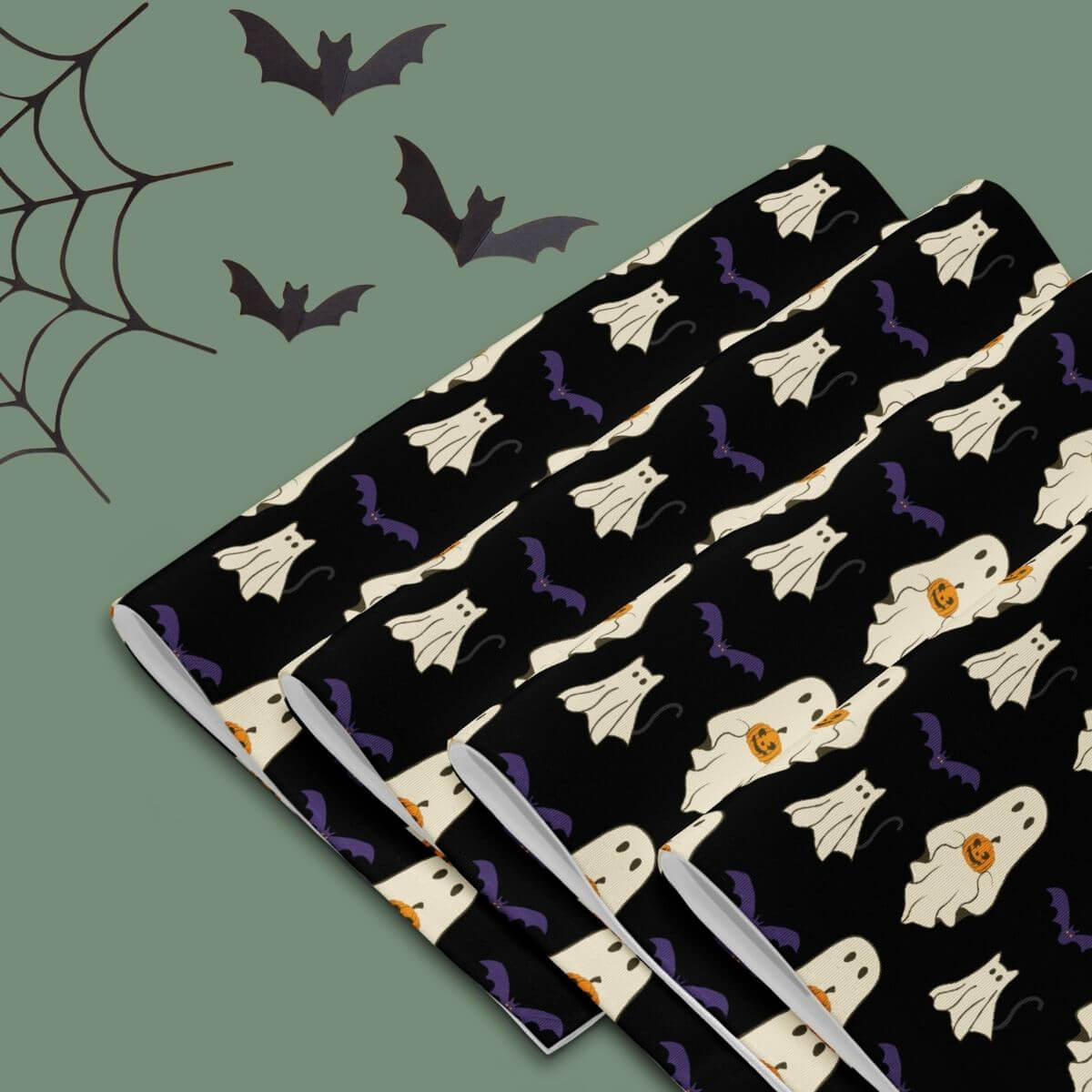 Halloween-themed placemats with a ghost and bat pattern on a black background