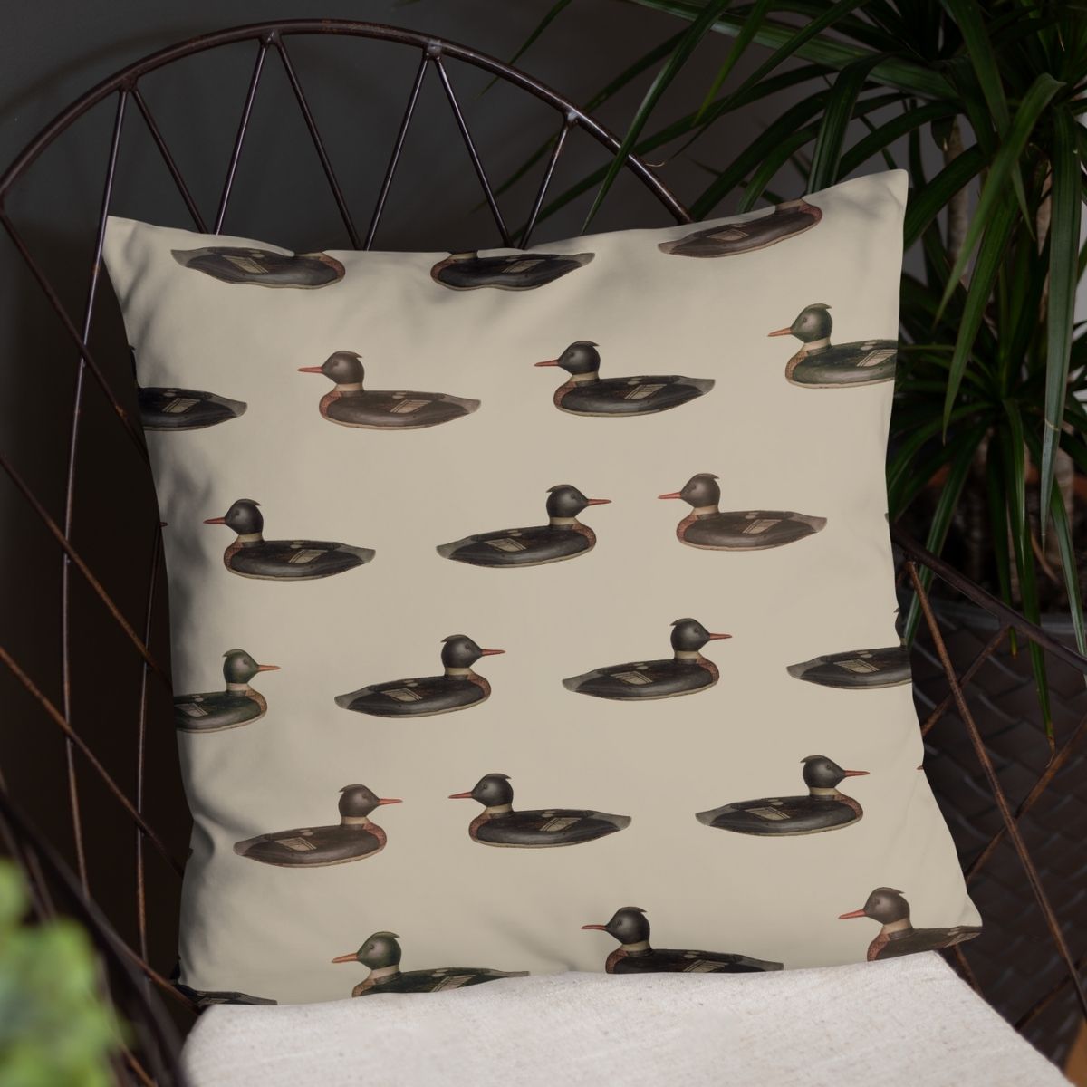 This pillow, shown in a metal framed chair with a dark background, is perfect for those who are looking to add a playful yet nostalgic vibe to their space.