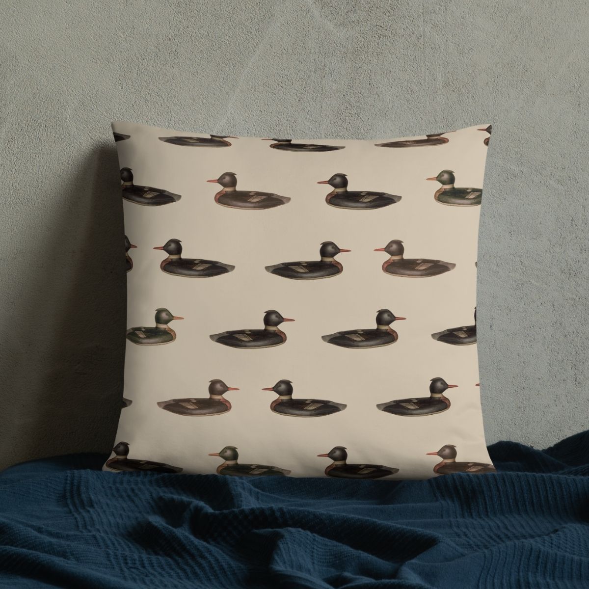 This pillow, shown here propped against a wall with a blanket, is perfect for those who are looking for a fun way to incorporate some nostalgic camp vibes into their home.
