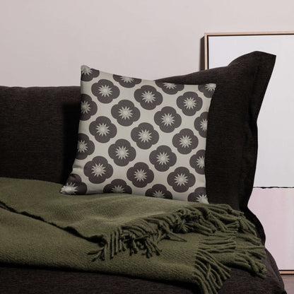 This satin-polyester pillow adds a cozy vintage charm to any room with its soft fabric and floral pattern in neutral colors.