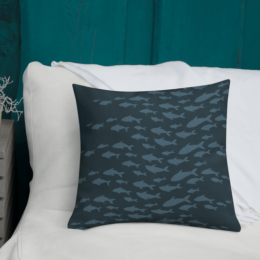 Decorative pillow with fish pattern on a white couch against a teal wall, perfect for creating a seaside vibe.