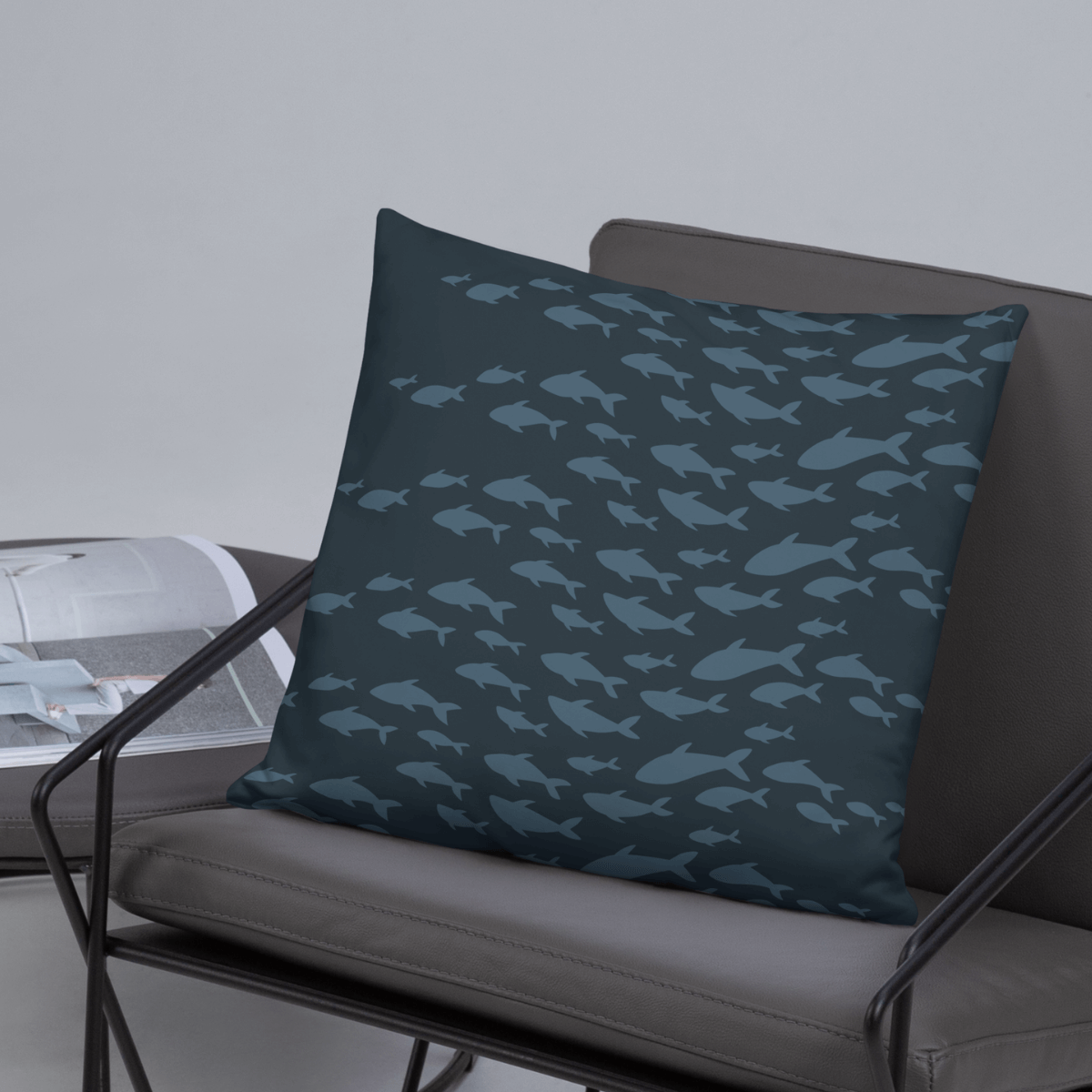 Blue nautical fish patterned pillow in a modern metal frame chair.