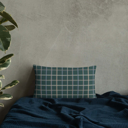 The Glen lumbar pillow adds a touch of whimsy and cozy charm to any room in the house with its pastel plaid pattern set against a dark green.