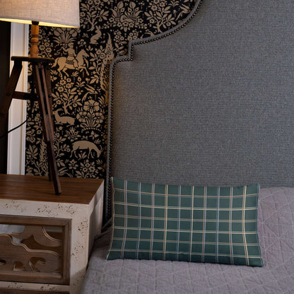 The Glen decorative lumbar throw pillow adds a cozy whimsical feel to the bedroom with its pastel plaid design against a midnight green background.