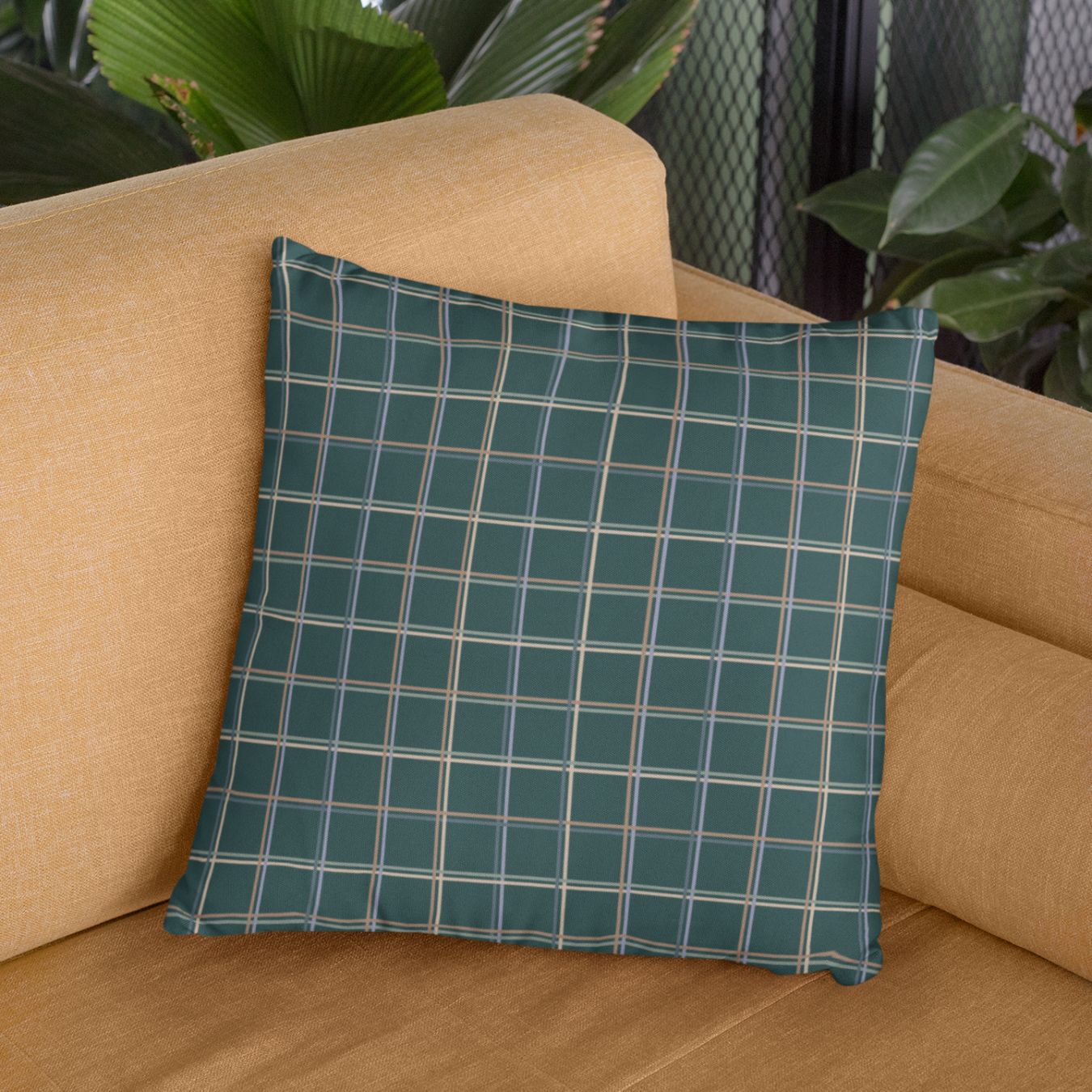 The Glen colorful throw pillows for tan couch add an inviting feel to any room with its pastel plaid pattern over a dark green background.