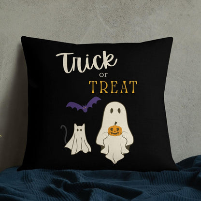 Black pillow with Halloween-themed design featuring a ghost, cat, and bat on a dark background.