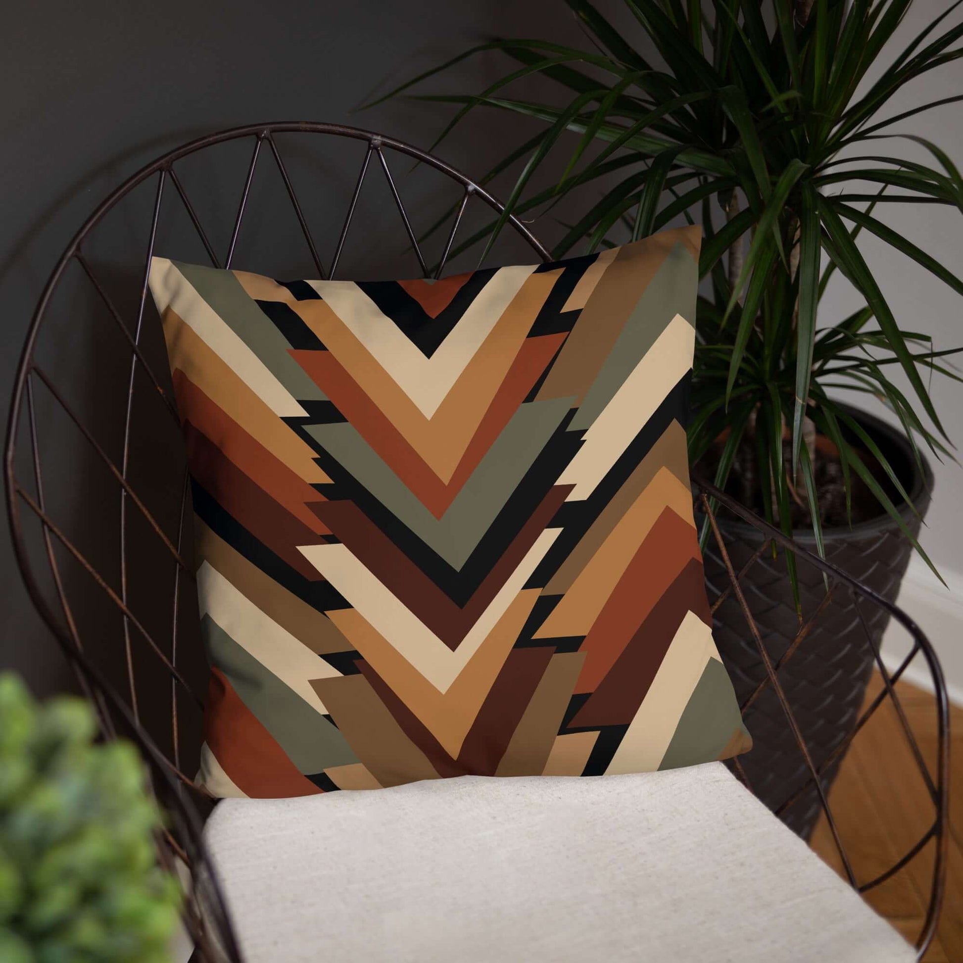 The geometric throw pillow shown in a modern accent chair, is perfect for living rooms and bedrooms alike.