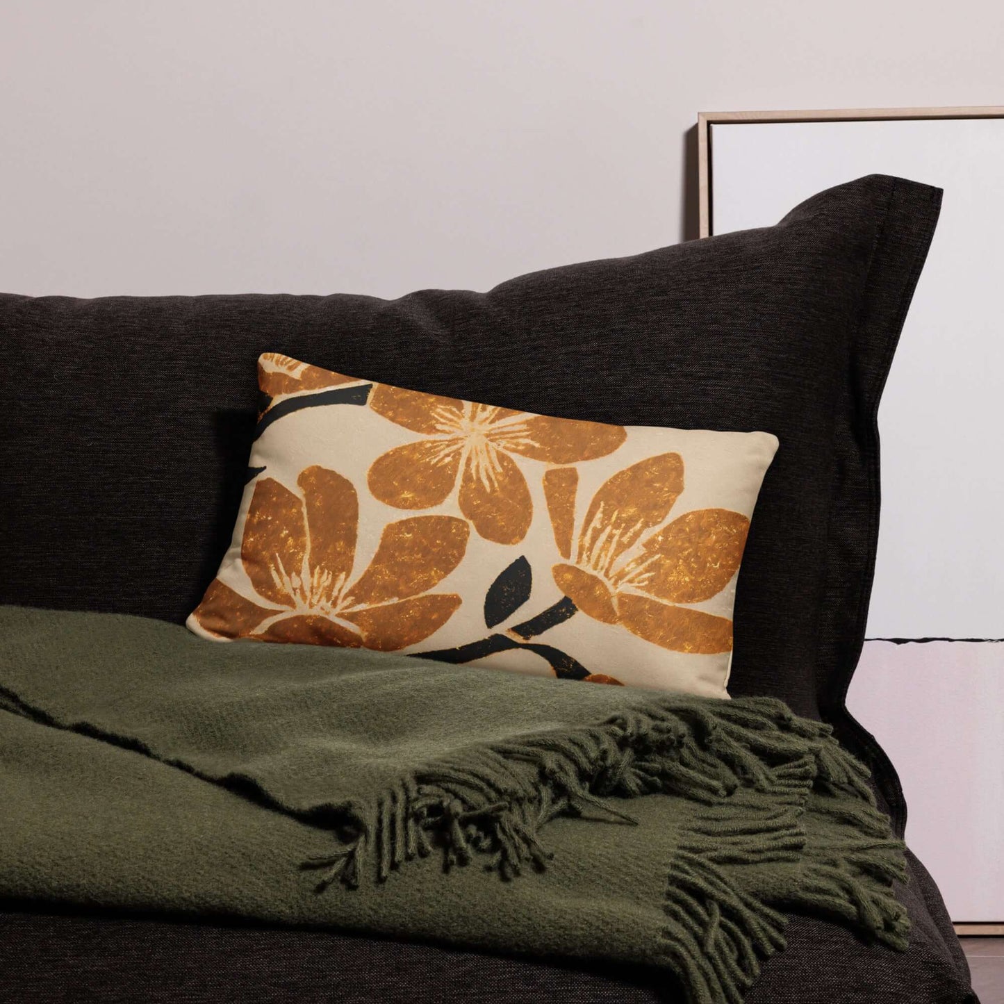 The popular kiva floral pillow on a green couch.