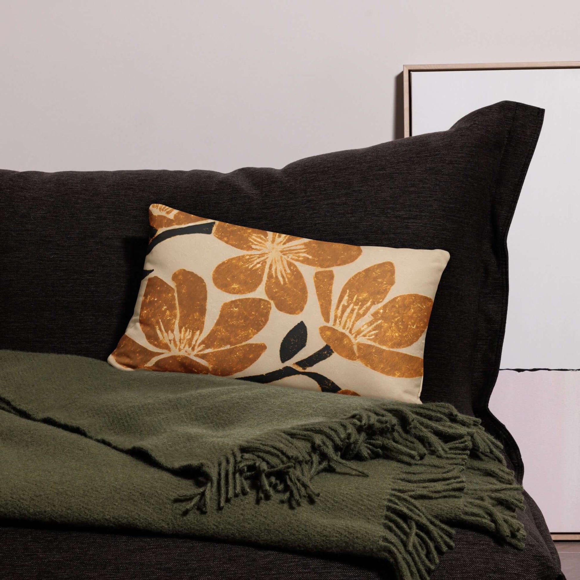 The popular kiva floral pillow on a green couch.