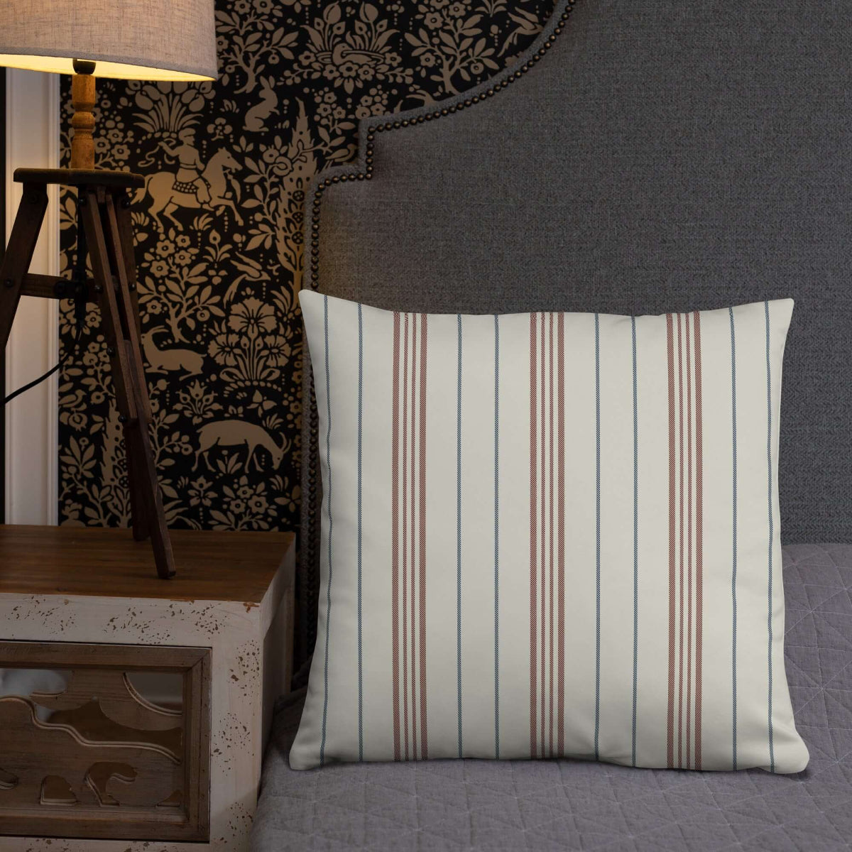 The neutral meadow striped decorative throw pillow in a gray bed