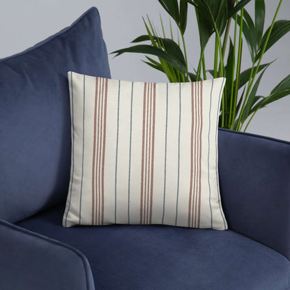 The meadow striped accent throw pillow in a blue accent chair