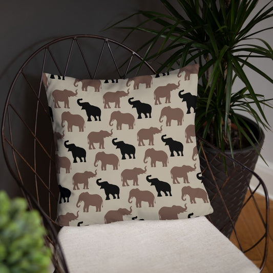 This throw pillow, featuring a neutral elephant pattern on the front side and striped on the back, paired with a chair next to a plant, is perfect for living rooms, kids' rooms, and nurseries.