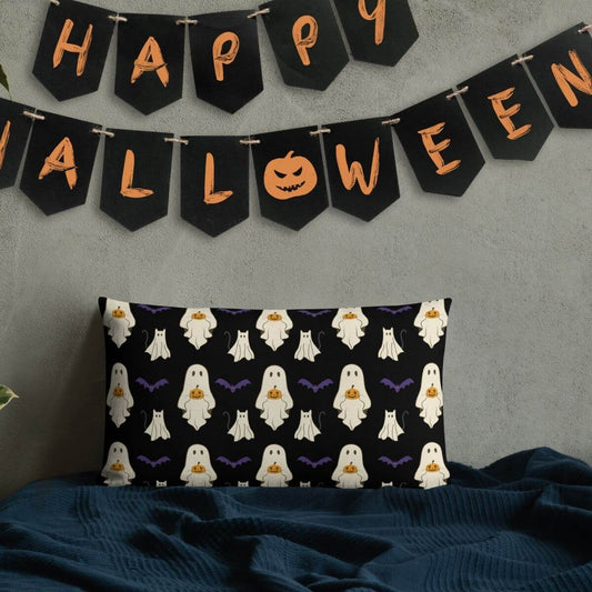 Halloween-themed pillow with ghost pattern and 'Happy Halloween' banner on a gray wall.